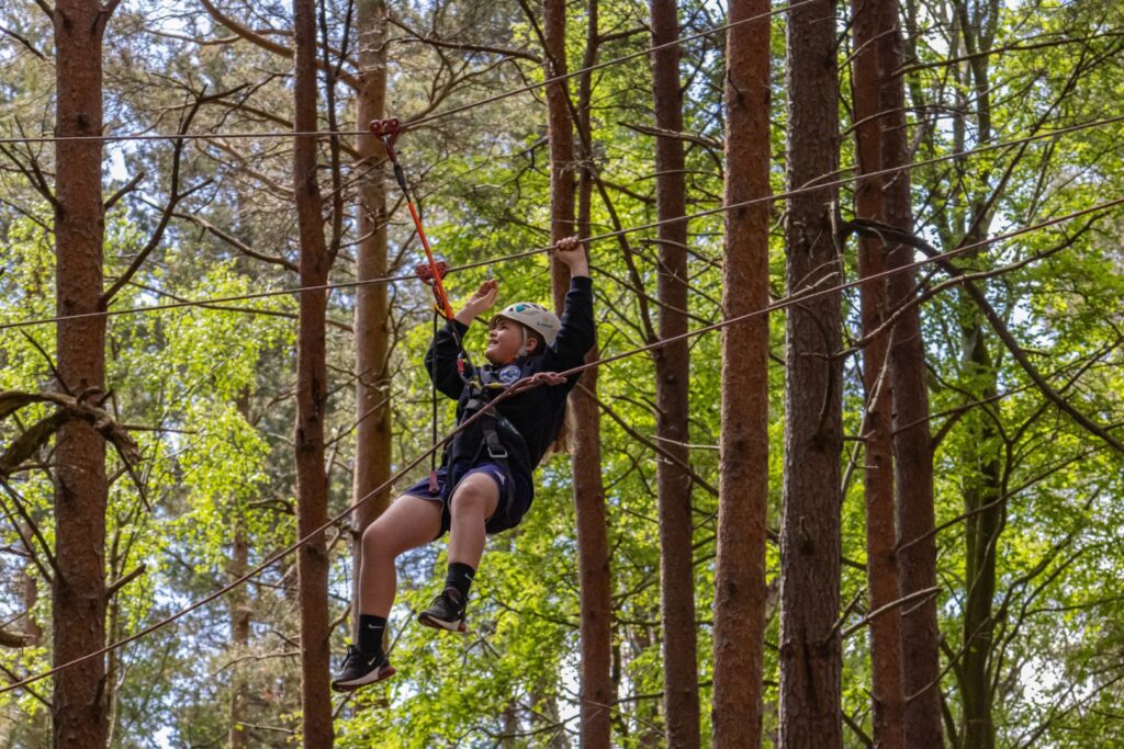 Young person on a tree assault course.